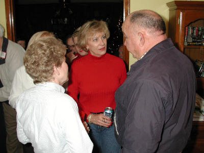 Jane Jones and Marilyn Smith welcome Coach Bill Schofield, always a welcome visitor for the class reunions.