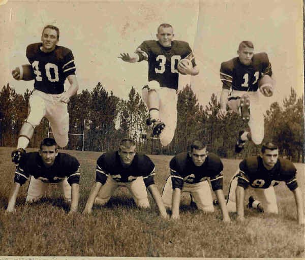 Seven LHS football players posed in two rows