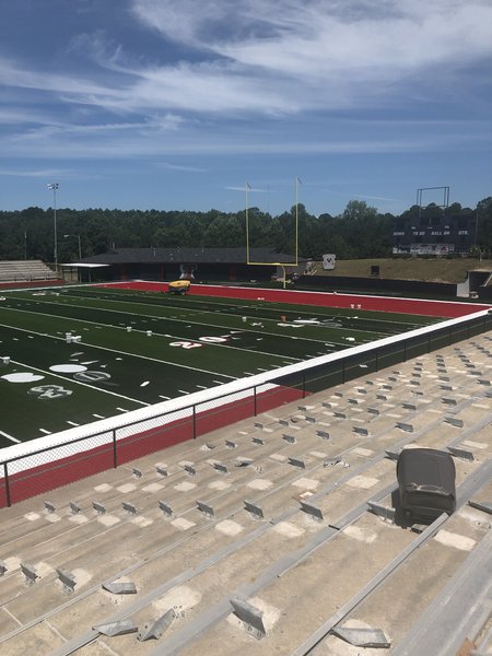 Pre-fab numbers are sewn into the carpet. No more lining and numbering the field the day before games. The turf is cut out and numbers are l